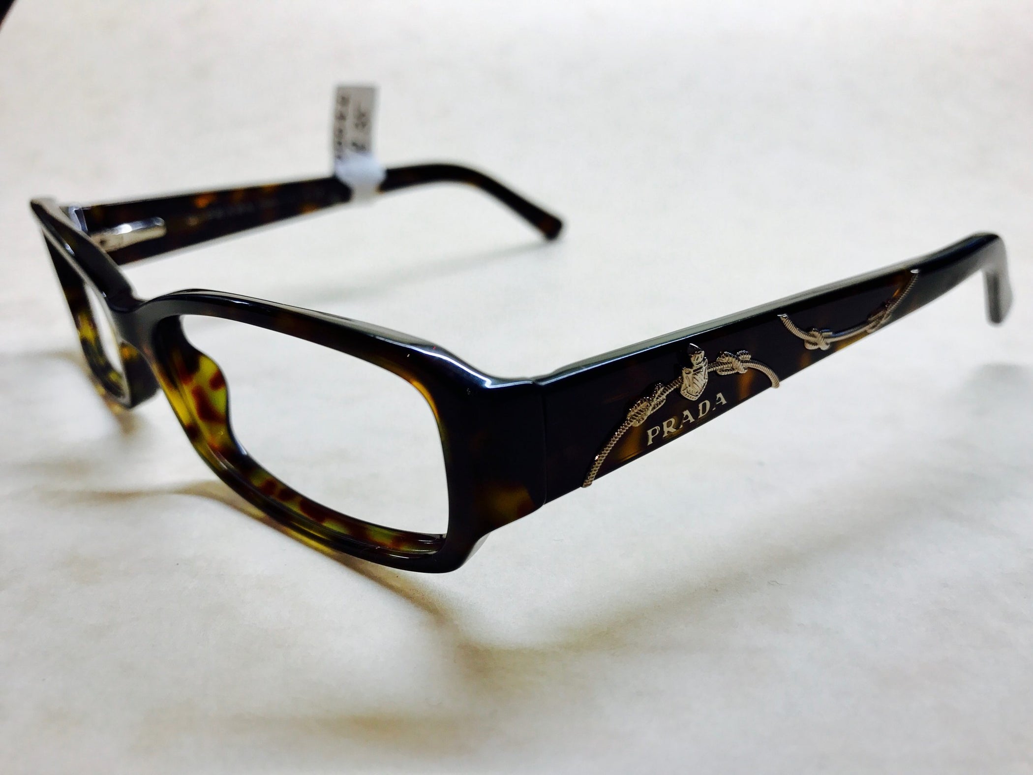 Dark tortoiseshell Prada frames with delicate silver detail on sides