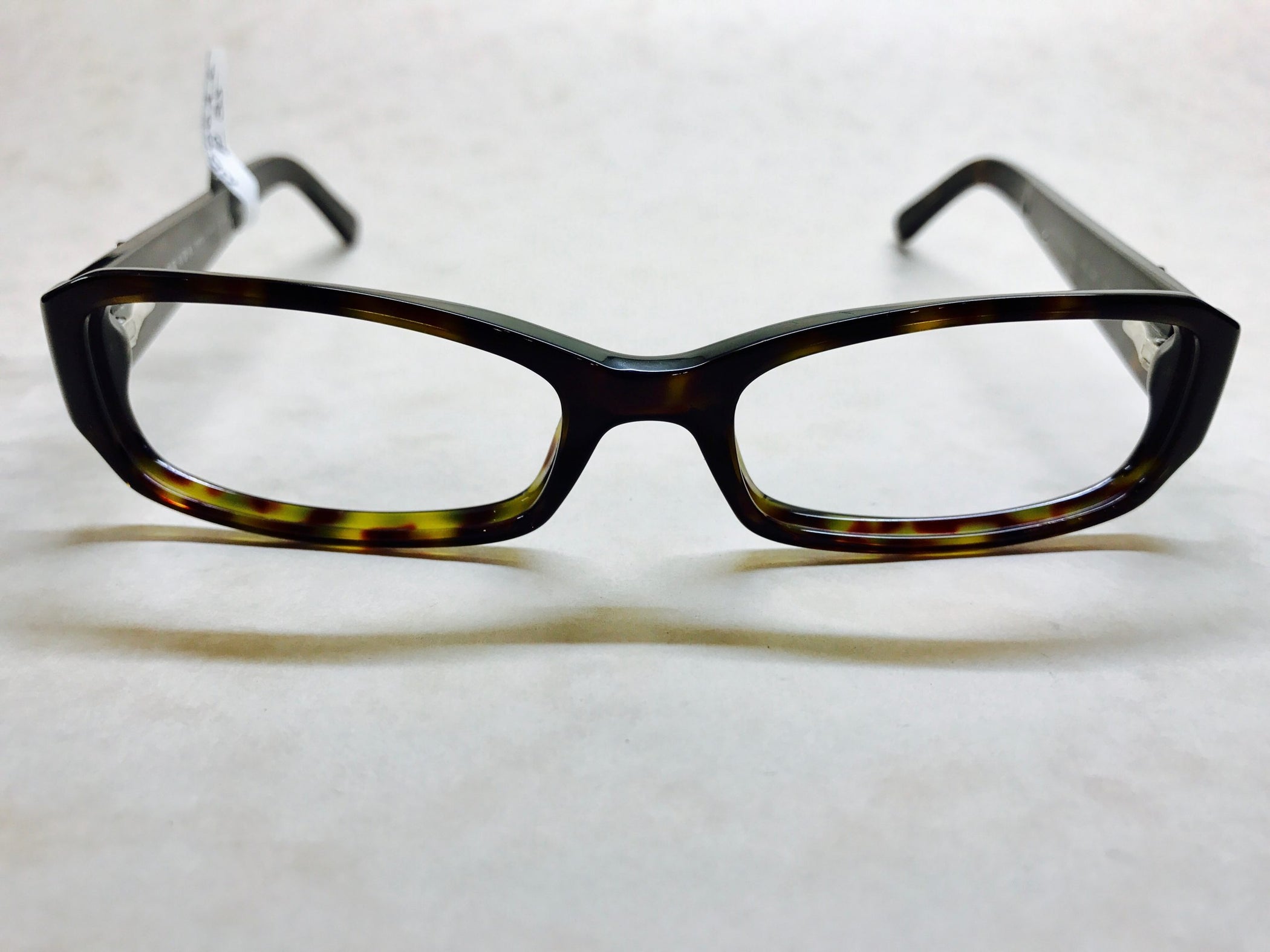 Dark tortoiseshell Prada frames with delicate silver detail on sides