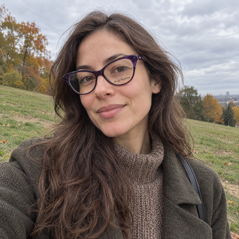 Purple cat-eye glasses with upswept corners and silver rivet accents